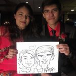 a man and woman holding a caricature