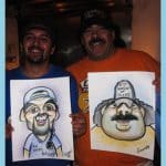 Two smiling guys proudly holding their caricature drawing by artist Grant at an event.